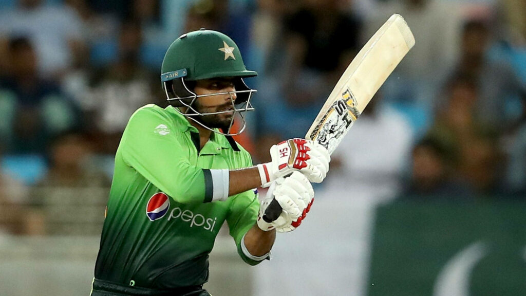 Babar Azam playing a powerful cricket shot focused during intense Pakistan cricket match wallpaper