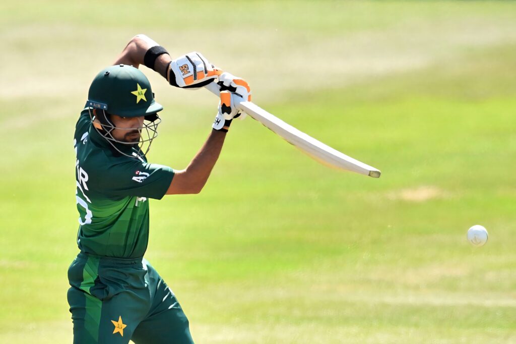 Babar Azam playing a skillful cricket shot on field dynamic wallpaper background action image