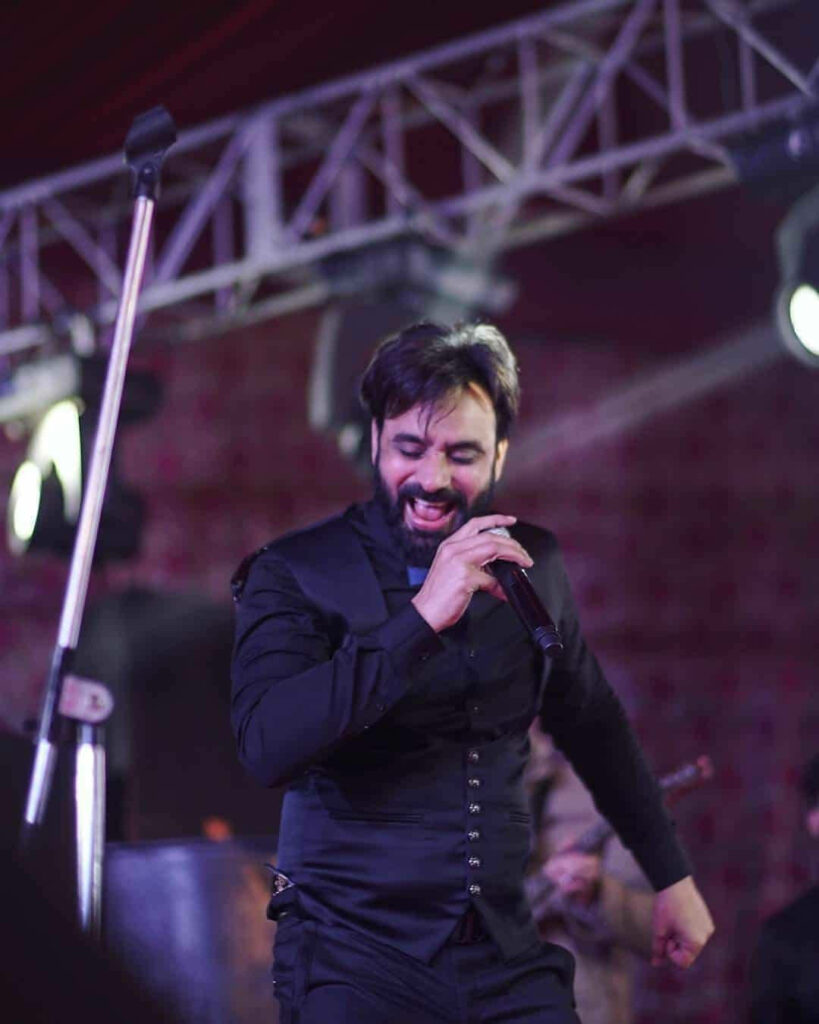 Babbu Maan energetic live stage performance captivating audience dynamic wallpaper background