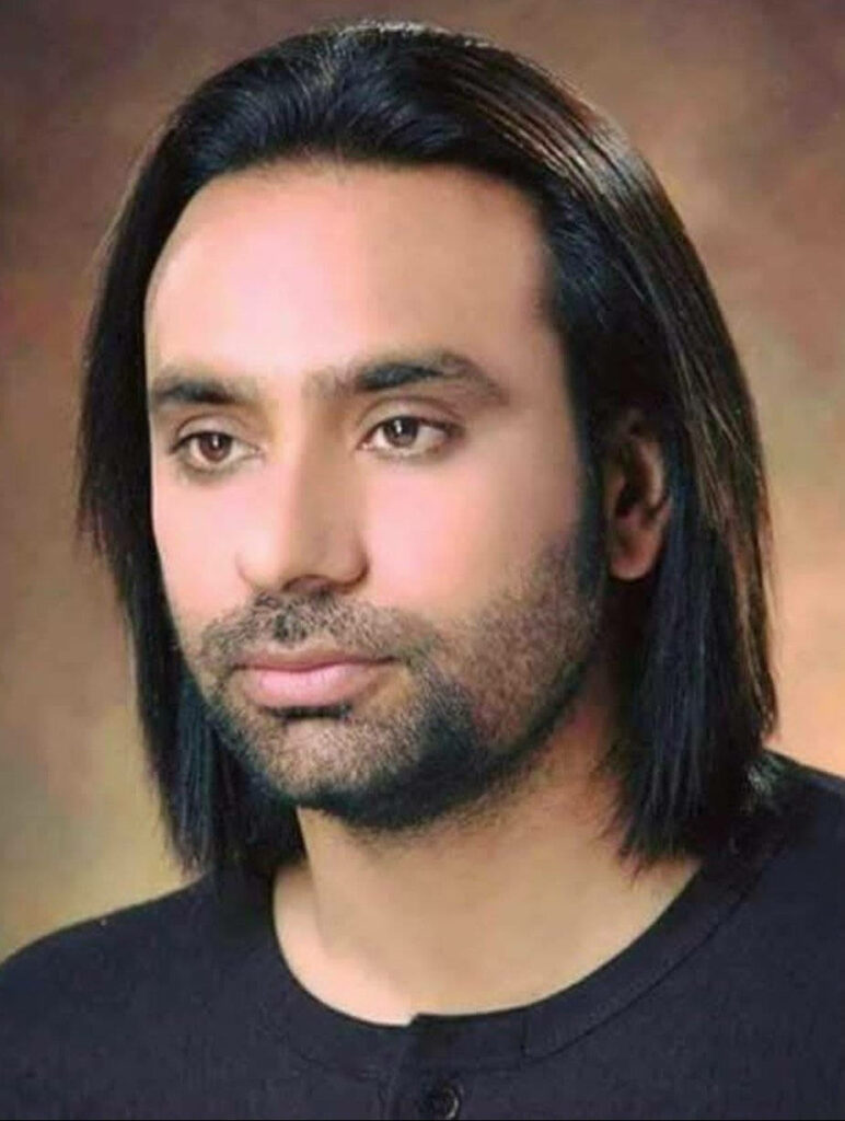 Babbu Maan portrait with calm expression long hair and groomed beard on soft studio background Wallpaper
