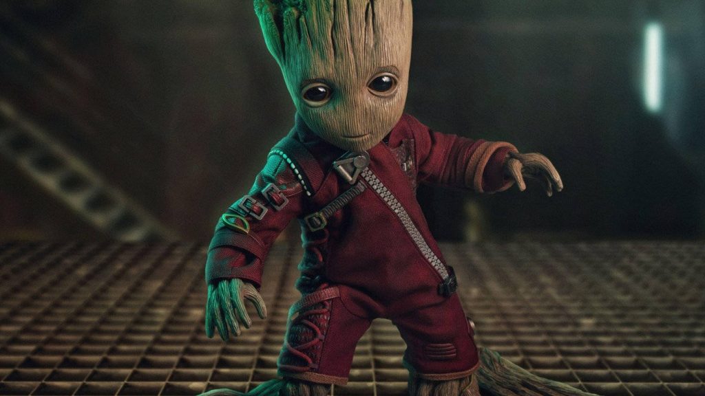 Baby Groot in red Ravager suit on metal grate with moody lighting CGI Guardians wallpaper