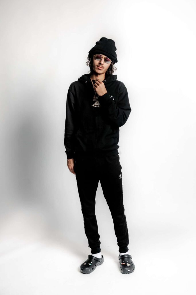 BabyTron American rapper in black hoodie and beanie standing confidently on white background Wallpaper
