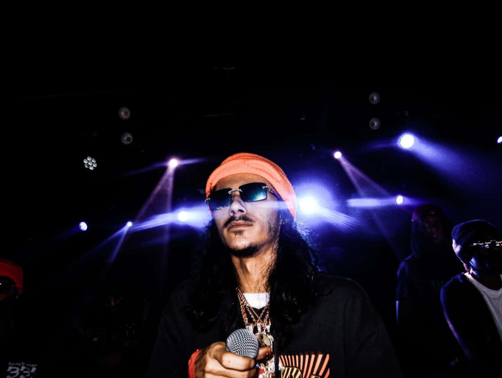 BabyTron American rapper performing on stage with vibrant lights showcasing his signature style Wallpaper