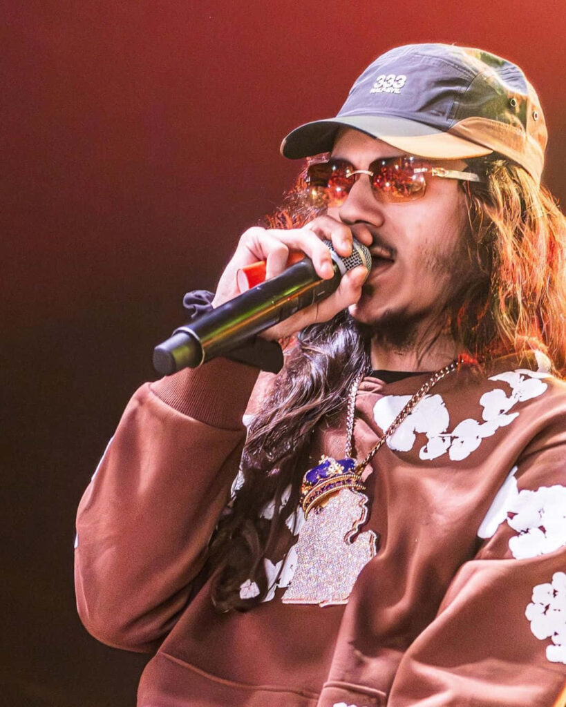 BabyTron performing on stage wearing sunglasses and brown sweatshirt energetic American rapper Wallpaper