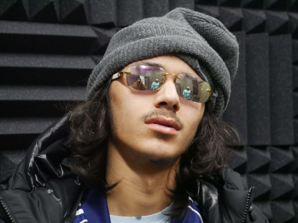 BabyTron American rapper wearing sunglasses and beanie textured studio wallpaper background