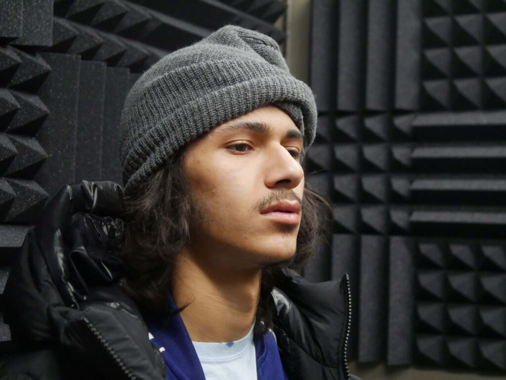 BabyTron in gray beanie and black jacket recording studio American rapper focused on music wallpaper background