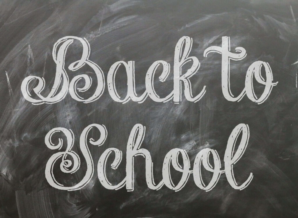 Back to School chalkboard wallpaper with bold white chalk lettering and nostalgic classroom vibe