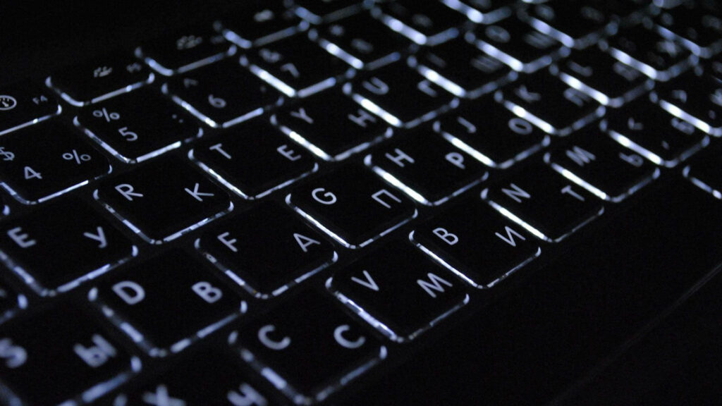 Close-Up Backlit Keyboard Wallpaper: Modern Tech Design Background