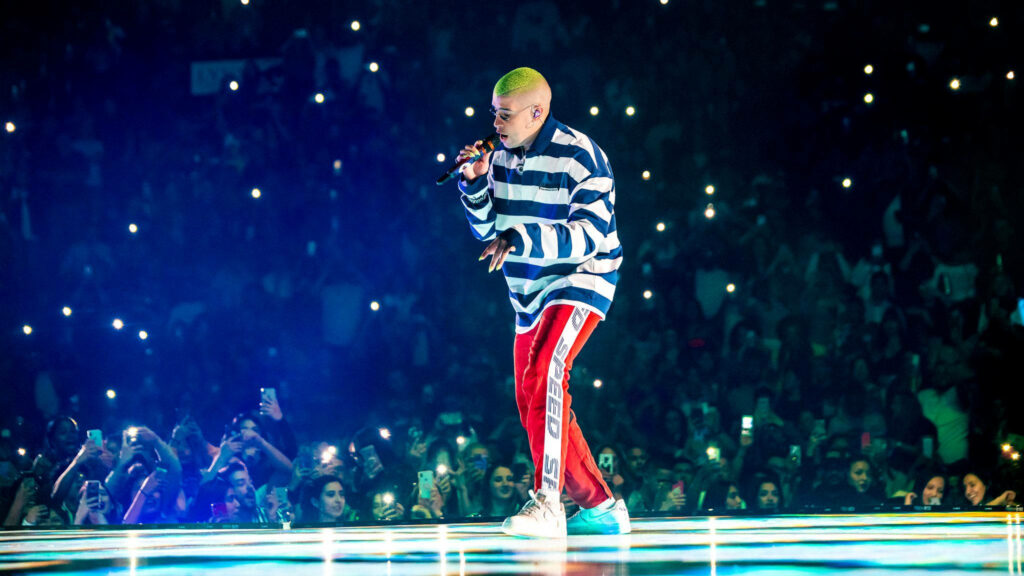 Unleashing Energy: Bad Bunny Electrifies Fans with Striped Sweater Swagger Wallpaper