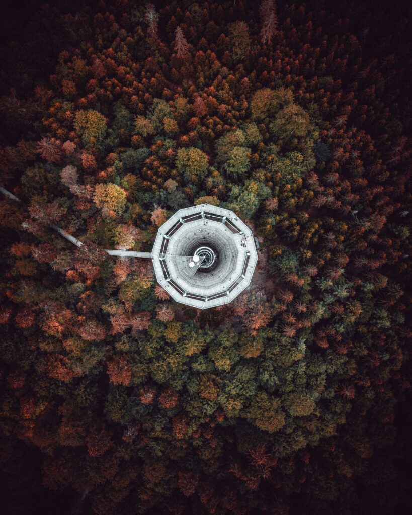 Aerial view of tower in Bad Wildbad Germany surrounded by colorful autumn forest foliage Wallpaper