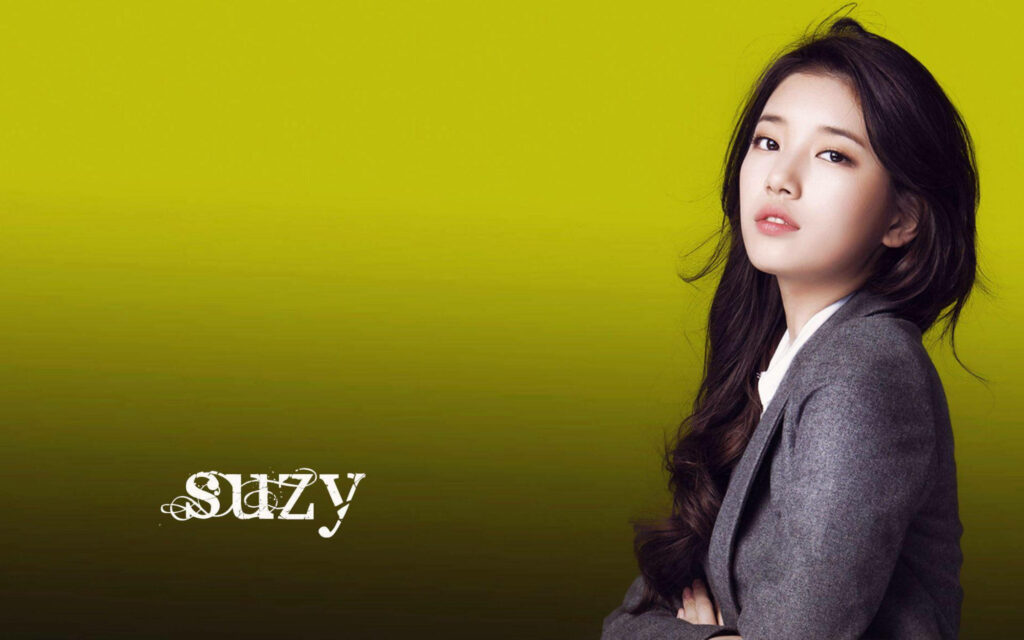 Bae Suzy from Miss A confident in gray blazer yellow gradient background stylish name text wallpaper