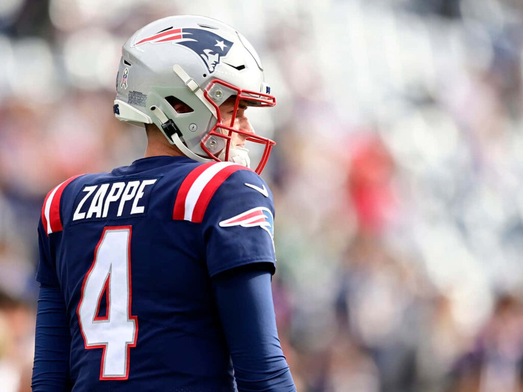 Bailey Zappe in New England Patriots uniform focused on field ready for game wallpaper background