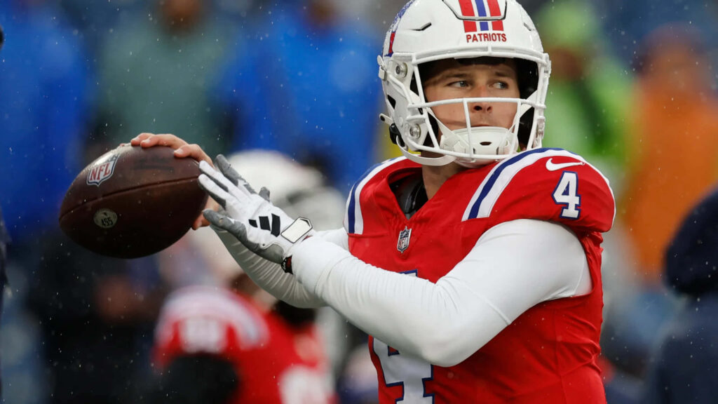 Bailey Zappe New England Patriots quarterback in action preparing to throw football during game Wallpaper