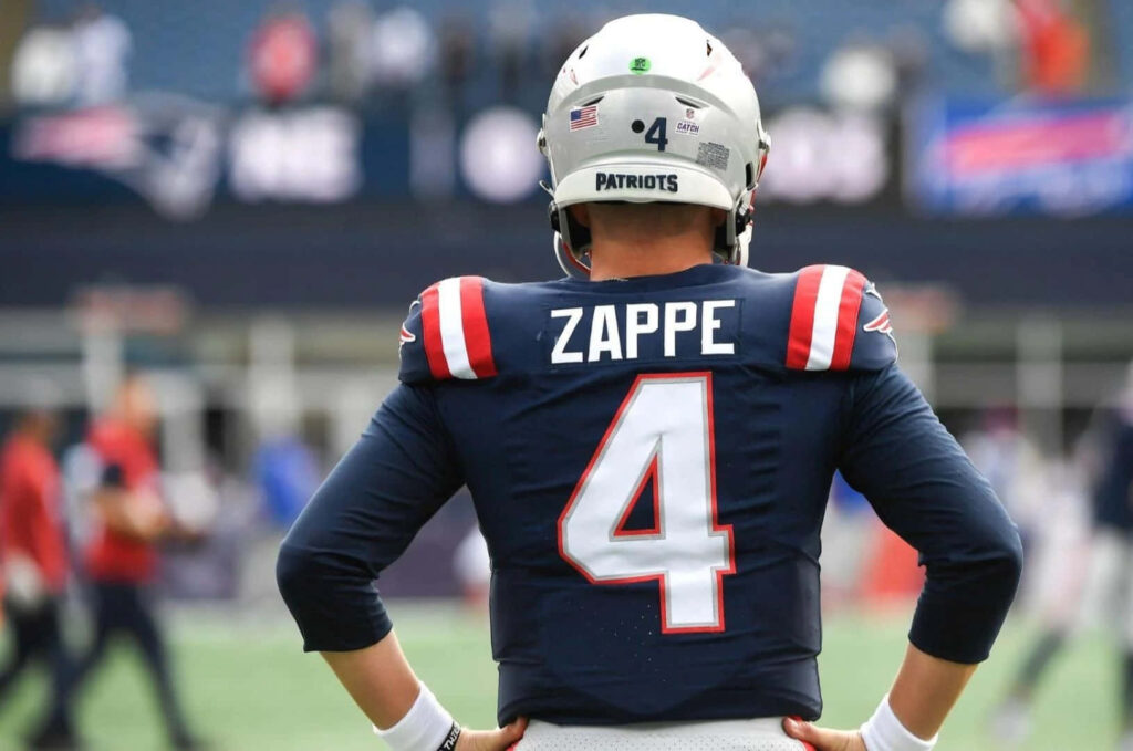 Bailey Zappe New England Patriots jersey number 4 standing on football field wallpaper background