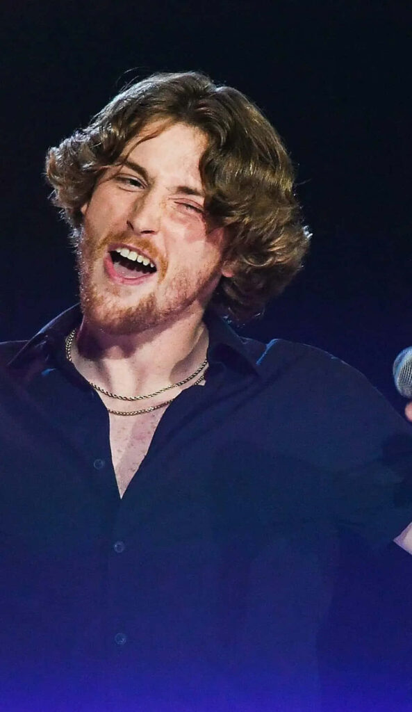 Bailey Zimmerman energetic live performance singing on stage microphone dynamic wallpaper background