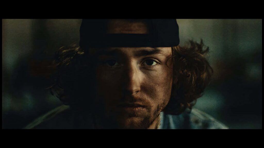 Bailey Zimmerman intense gaze wearing cap moody dramatic wallpaper background for fans