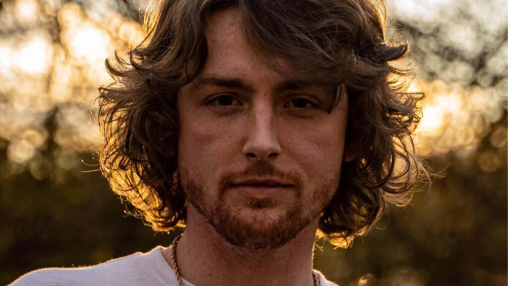 Portrait of country singer Bailey Zimmerman with warm natural backlighting and relaxed style Wallpaper