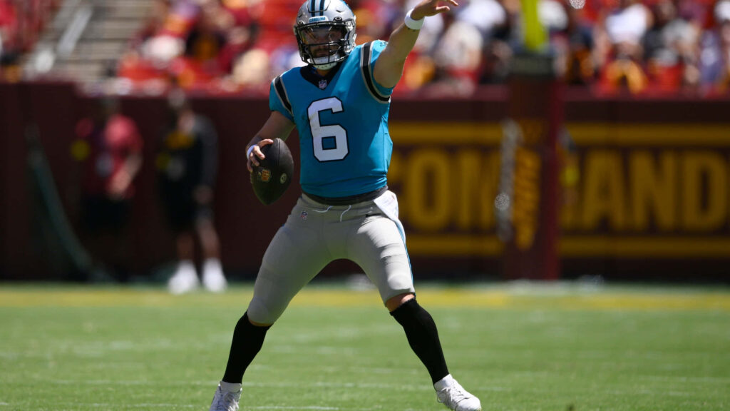 Baker Mayfield throwing football in Carolina Panthers uniform focused during game action wallpaper