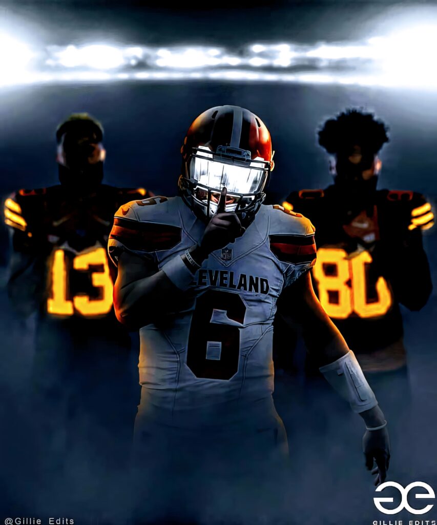 Baker Mayfield in Cleveland Browns uniform with teammates under stadium lights showing team unity Wallpaper
