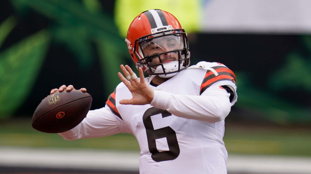 Baker Mayfield throwing football on field dynamic wallpaper background in action pose