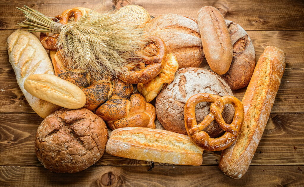 Bread's Golden Delight: An HD Still Life of Baking Wonders Wallpaper