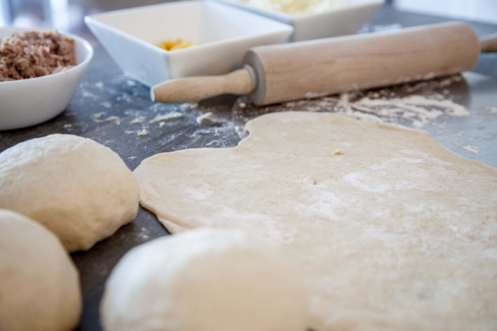 Close-Up of Baking Prep: Dough Rolling with Wooden Pin & Ingredients Wallpaper