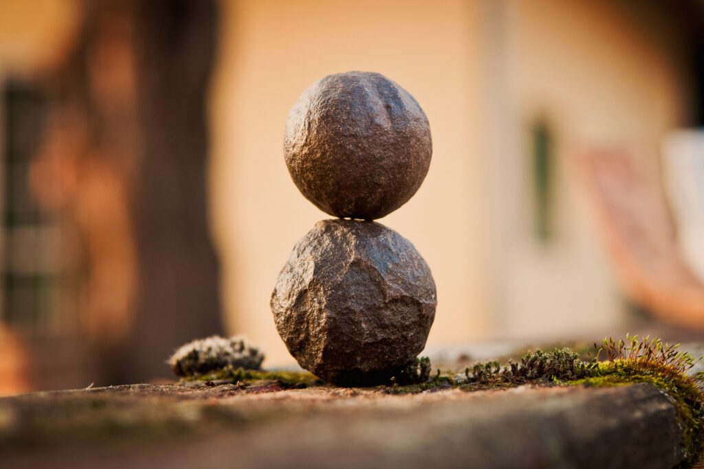 Close up of balanced round stones with soft moss natural textures peaceful organic wallpaper