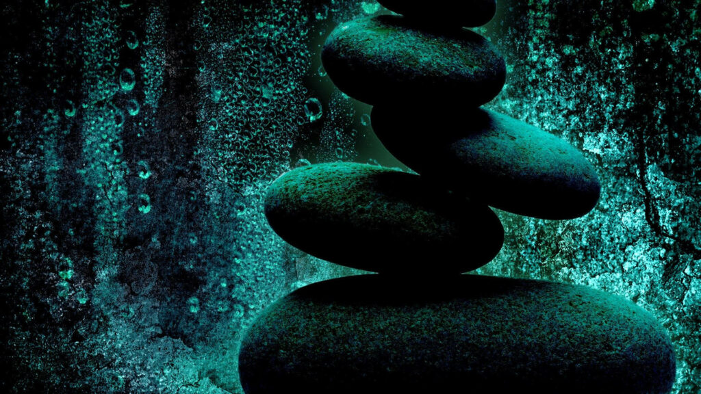 Balancing Act: HD Wallpaper of Stones Balanced in a Green Abstract Background