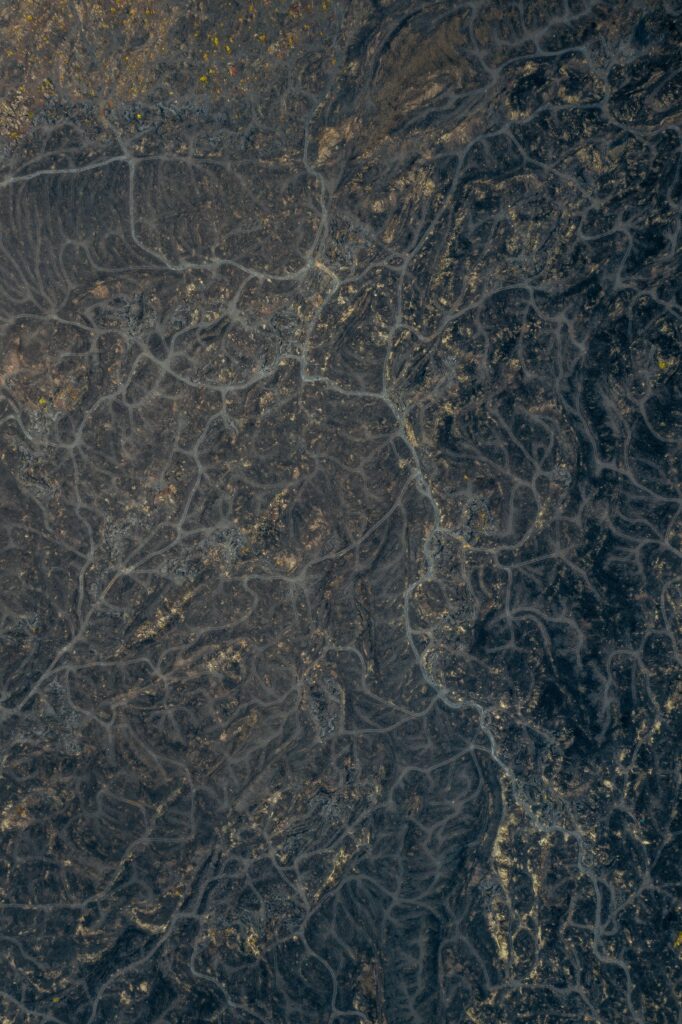 Aerial view of Bali volcanic landscape with rugged lava fields and textured mountain reliefs Wallpaper