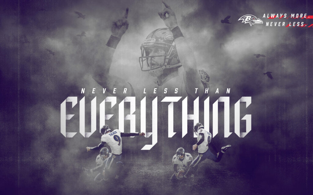 Baltimore Ravens players in action with Never Less Than Everything slogan on misty background wallpaper