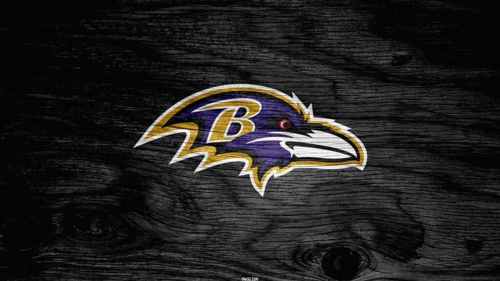 Baltimore Ravens emblem on dark textured wood background showcasing purple gold black colors Wallpaper