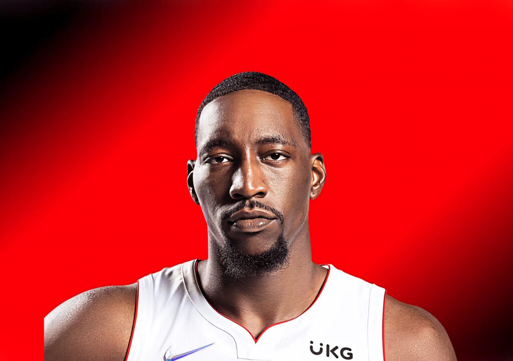 Bam Adebayo in basketball jersey posing confidently against a vibrant red background wallpaper