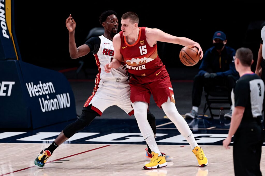 Bam Adebayo defends Nikola Jokic in intense NBA game showcasing basketball focus and defense Wallpaper