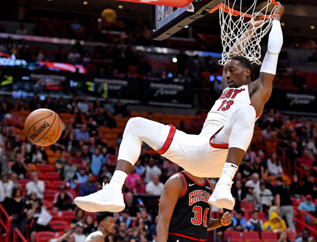 Miami Heat Bam Adebayo dunking fiercely during a thrilling basketball game action shot wallpaper