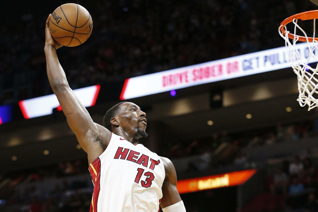 Bam Adebayo mid-air slam dunk for Miami Heat intense basketball action wallpaper background