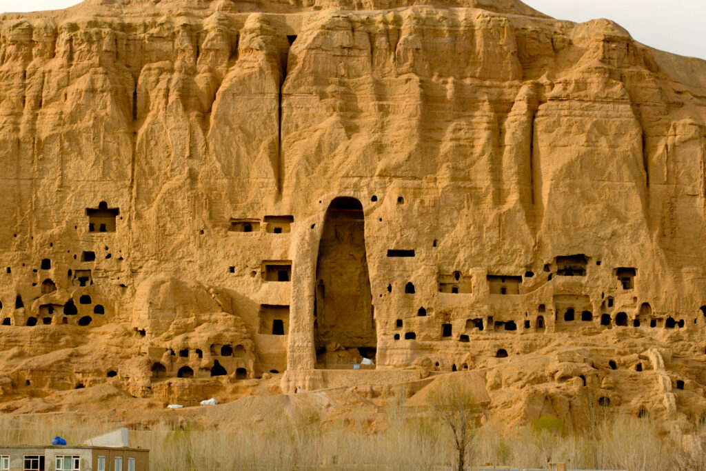 Ancient sandstone carvings of Bamiyan caves in Afghanistan rugged cliffs historic niches wallpaper