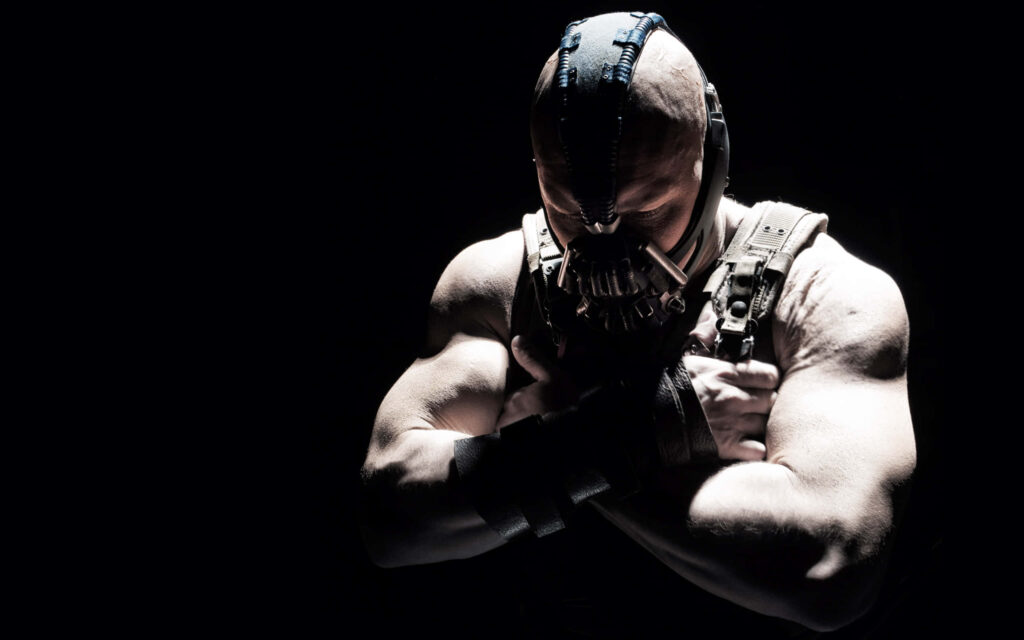 Bane from DC Comics with iconic mask muscular build arms crossed intense dark wallpaper background