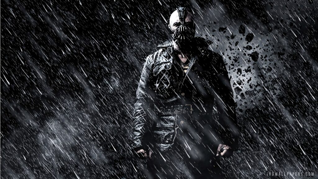 Bane from DC Comics stands fiercely in rain dark tones flying debris dramatic intense wallpaper background