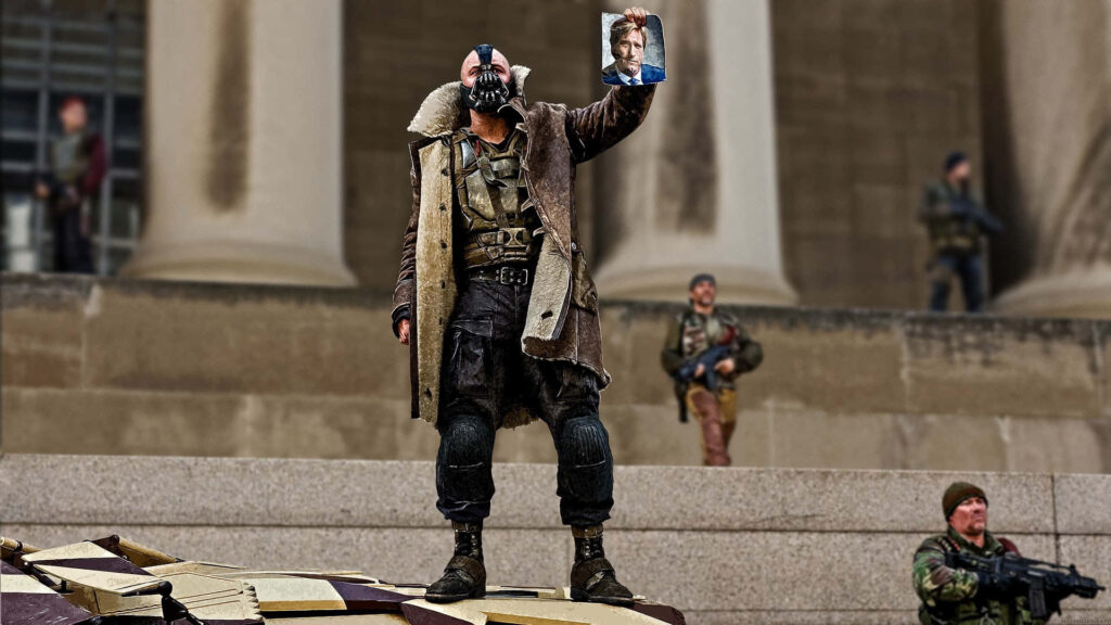 Bane in mask and heavy coat on rubble holding photo with armed men outside grand building DC Comics Wallpaper