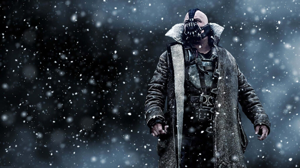 Bane from DC Comics in iconic mask and coat standing strong in a snowy storm wallpaper background