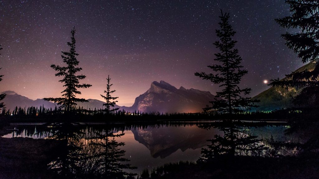 Mount Rundle at night reflecting in Vermilion Lakes with pine silhouettes Banff wallpaper