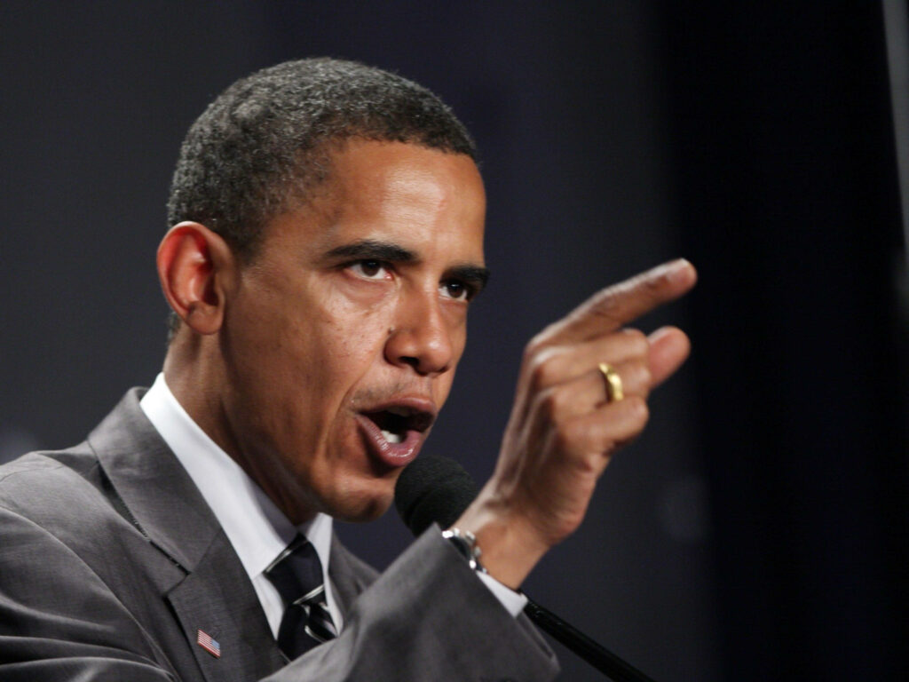 Barack Obama with fierce determined expression pointing forward showing leadership and power Wallpaper