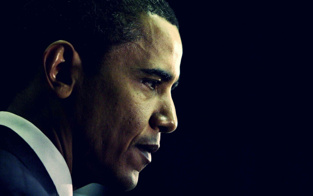 Side profile of Barack Obama with thoughtful expression on dark minimalist wallpaper background