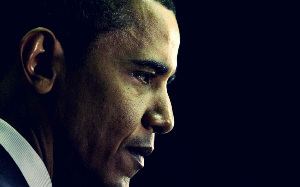 Barack Obama thoughtful side profile portrait on dark background wallpaper for inspirational use