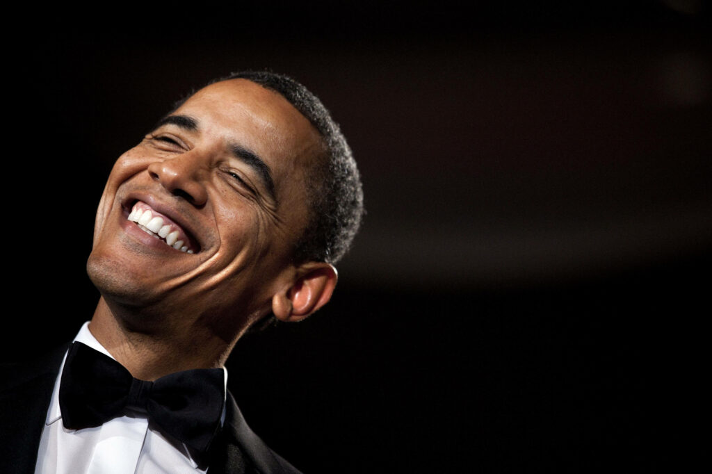 Barack Obama smiling warmly in formal attire vibrant presidential wallpaper background