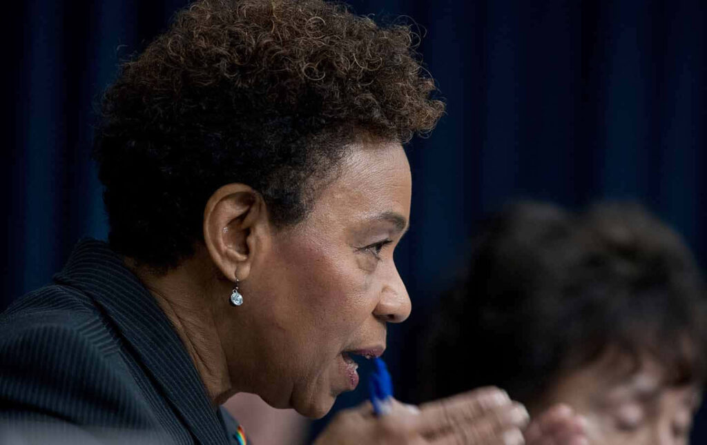 Side profile of Barbara Lee in thoughtful discussion showing leadership and dedication wallpaper