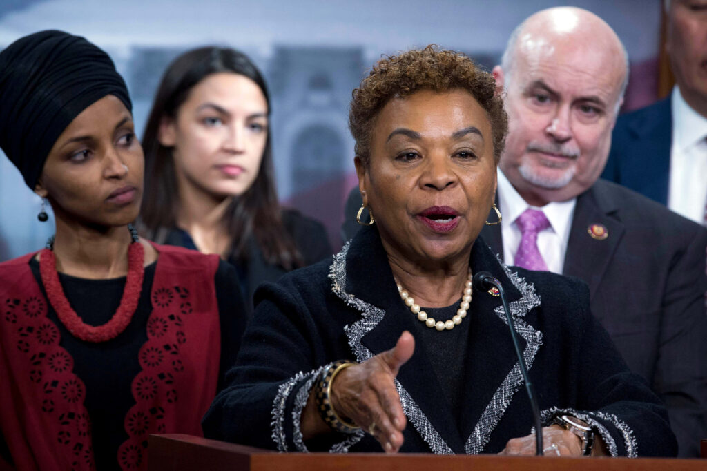 Barbara Lee speaking at press conference with members behind her showing political unity and leadership Wallpaper