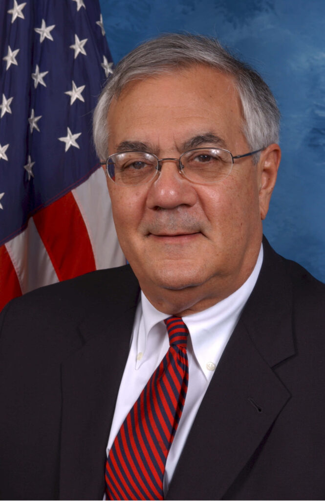 Barney Frank formal portrait wearing suit and tie with American flag professional dignified background Wallpaper