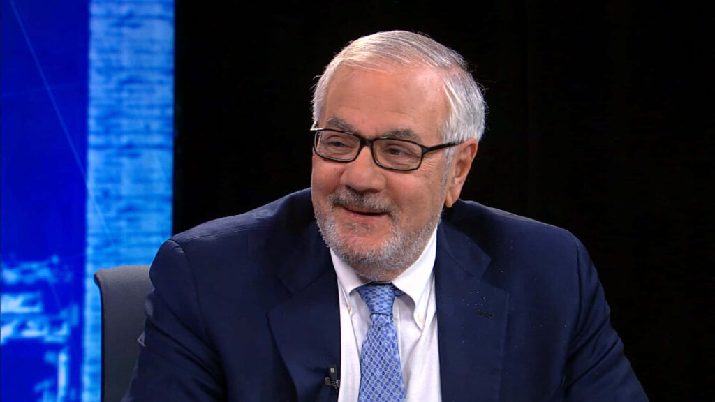 Barney Frank smiling warmly in suit and tie friendly approachable professional wallpaper background