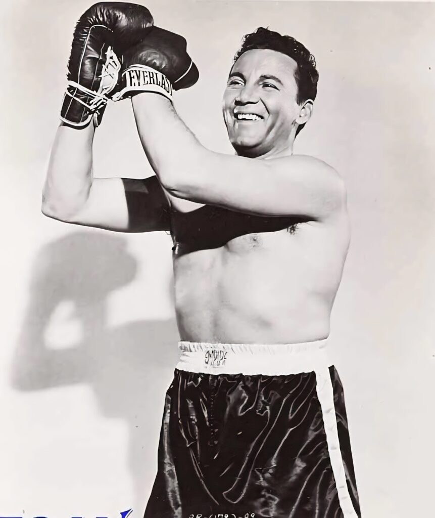 Barney Ross smiling confidently in boxing gloves and shorts vintage boxing wallpaper background